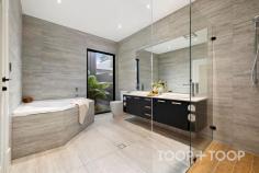  3 Smith St Walkerville SA 5081 A Serene Walkerville Oasis of Timeless Charm and Contemporary Luxury This captivating residence beautifully blends classic character with modern sophistication, featuring a charming 1925 bungalow at the front seamlessly extended to the rear with soaring 3.6-metre high ceilings and open-plan living designed for today’s lifestyle. Set in the prestigious heart of Walkerville and moments from elite schools including St Andrew’s School and Wilderness School, this home offers a rare fusion of heritage appeal and contemporary comfort, just minutes from the CBD. Step inside to discover the warmth of the original bungalow enhanced by luxurious herringbone direct-stick timber flooring, flowing effortlessly into the expansive modern extension. The open-plan living and dining area is flooded with natural light through commercial-grade aluminium windows and doors by South Pacific Windows and Doors that open seamlessly to a tranquil undercover alfresco entertaining space. At the heart of the home is a designer kitchen featuring sleek cabinetry, a large island bench, premium Miele appliances, and generous space for a double fridge or wine fridge setup, ideal for entertaining and daily family life. The residence offers the flexibility of dual master suites, perfect for multi-generational living or hosting guests. The primary master suite impresses with a luxurious ensuite and an oversized walk-in robe and private changing room reminiscent of a boutique retreat. Outside, the alfresco area is framed by established bamboo, providing a natural screen and peaceful ambiance for year-round enjoyment. A standout feature is the air-conditioned double garage, fully lined with premium plywood panelling and LED downlights—a versatile space perfect for conversion into a home gym, creative studio, or indoor golf simulator. Additional modern comforts include two zoned ducted reverse-cycle air conditioning systems and three instantaneous hot water systems, ensuring efficiency and comfort throughout. The property is further enhanced by an elegant feature stone wall fence, adding a sophisticated touch of timeless style while ensuring enhanced privacy and security. Complementing this is a heavy-duty steel gate, providing robust and secure access that perfectly balances form and function. Highlights include: Original 1925 bungalow blended with a modern extension featuring 3.6m high ceilings Elegant herringbone direct-stick timber flooring Commercial-grade aluminium windows and doors by South Pacific Windows and Doors Dual master suites offering flexible living arrangements Luxe main suite with expansive ensuite and walk-in robe / changing room Designer kitchen with island bench and space for wine/double fridge Luxury Covered alfresco entertaining area bordered by established bamboo Air-conditioned double garage with plywood lining and LED downlights – ideal for studio or golf simulator Three instantaneous hot water systems Luxury German Grohe taps throught out the entired home Two zoned ducted reverse-cycle air conditioning systems Double garage plus additional carport Prime location near Adelaide CBD, Linear Park, cafés, and top private schools 3 Smith Street perfectly marries timeless charm with contemporary elegance, creating a sophisticated lifestyle in one of Adelaide’s most coveted suburbs. 