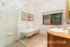  94 Tanahmerah Rd Balhannah SA 5242 Timeless elegance radiates with abundance around this stunning Carey Gully stone and brick residence surrounded by gorgeous English cottage gardens and the rolling hills of Balhannah. An exquisite marble entrance complete with delicate lead light windows opens up to a breathtaking home designed to provide both luxury and comfort, while amplifying the stunning surrounds of designer garden and natural bushland. The entrance of the residence opens up to an expanse of living and dining spaces, all surrounding a warm and light filled atrium at the heart of the home. A formal lounge and dining room present a picturesque space to entertain in comfort while the glass and timber atrium, equipped with underfloor heating is a testament to the meticulous attention to detail and functionality that characterise this home. The timeless parquet floors that flow throughout the home are complimented by the floating floorboards that grace the kitchen and dining areas. Four generous bedrooms surrounding the central atrium offer ample space for living and storage along with charming views of the surrounding scenery, while the majestic master suite boasts an elegant bathroom and spacious walk-in robe. The flexibility of the layout allows for a configuration of three bedrooms or the option to create a study space for those seeking a home office. Moving through the retreat style atrium, a grand American Oak kitchen hosts a large walk-in pantry, Belling oven and exhaust fan, and a Miele dishwasher. This space is enhanced by a spacious casual dining area featuring a Coalbrook Dale Wood Fire heater and surrounding scenic views to the manicured garden and rolling hills. Looking through the numerous, generous windows, an expansive verandah highlighted by hand-made terracotta edging tiles wraps around the home. Its 40 solar panels, ducted air conditioning and vacuum system further ensure eco-friendly, efficient and comfortable living. Beyond the immediate residence, the property unfolds into 25 acres of scenic beauty featuring 2 acres of meticulously maintained English Cottage style gardens. An automatic watering system and fully lit garden with lanterns and floor lights enrich the natural botanical splendour. At the southern aspect of the home, a large, light filled conservatory, surrounded by floor to ceiling glass walls, sets the stage for alfresco dining. With a fully-functional kitchen, the curated entertainment space caters for grand occasions, with space to seat sixty people in a round dining table setting. The exceptional functionality of the property is supported by a billabong, dam, bore and a valuable water license, adding convenience and potential to the opportunity. A farm shed, woodshed, and a double garage with automated doors offer abundant storage. The plot also homes 100 nut trees and 20 cherry trees, contributing to the landscapes breathtaking natural charm while delivering stunning views of native bushland. Set against this picturesque backdrop, this stunning residence is a perfect blend of classic charm and modern refinement, offering an idyllic retreat to unwind and entertain in style. This is a property that perfectly encapsulates the essence of luxury country living while remaining a testament to functional design. Location Highlights: + Situated on the scenic Mt George side of Balhannah + 10 minutes commute to the city + Close to iconic venues such as the Stanley Bridge and Uraidla Hotels, Hahndorf Hill winery and Ambleside Distillery +Zoned for Uraidla, Bridgewater and Oakbank Primary Schools, plus close to the Hills Christian and Cornerstone Colleges. 