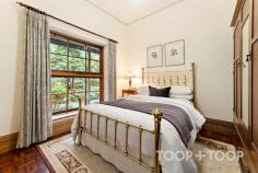  94 Tanahmerah Rd Balhannah SA 5242 Timeless elegance radiates with abundance around this stunning Carey Gully stone and brick residence surrounded by gorgeous English cottage gardens and the rolling hills of Balhannah. An exquisite marble entrance complete with delicate lead light windows opens up to a breathtaking home designed to provide both luxury and comfort, while amplifying the stunning surrounds of designer garden and natural bushland. The entrance of the residence opens up to an expanse of living and dining spaces, all surrounding a warm and light filled atrium at the heart of the home. A formal lounge and dining room present a picturesque space to entertain in comfort while the glass and timber atrium, equipped with underfloor heating is a testament to the meticulous attention to detail and functionality that characterise this home. The timeless parquet floors that flow throughout the home are complimented by the floating floorboards that grace the kitchen and dining areas. Four generous bedrooms surrounding the central atrium offer ample space for living and storage along with charming views of the surrounding scenery, while the majestic master suite boasts an elegant bathroom and spacious walk-in robe. The flexibility of the layout allows for a configuration of three bedrooms or the option to create a study space for those seeking a home office. Moving through the retreat style atrium, a grand American Oak kitchen hosts a large walk-in pantry, Belling oven and exhaust fan, and a Miele dishwasher. This space is enhanced by a spacious casual dining area featuring a Coalbrook Dale Wood Fire heater and surrounding scenic views to the manicured garden and rolling hills. Looking through the numerous, generous windows, an expansive verandah highlighted by hand-made terracotta edging tiles wraps around the home. Its 40 solar panels, ducted air conditioning and vacuum system further ensure eco-friendly, efficient and comfortable living. Beyond the immediate residence, the property unfolds into 25 acres of scenic beauty featuring 2 acres of meticulously maintained English Cottage style gardens. An automatic watering system and fully lit garden with lanterns and floor lights enrich the natural botanical splendour. At the southern aspect of the home, a large, light filled conservatory, surrounded by floor to ceiling glass walls, sets the stage for alfresco dining. With a fully-functional kitchen, the curated entertainment space caters for grand occasions, with space to seat sixty people in a round dining table setting. The exceptional functionality of the property is supported by a billabong, dam, bore and a valuable water license, adding convenience and potential to the opportunity. A farm shed, woodshed, and a double garage with automated doors offer abundant storage. The plot also homes 100 nut trees and 20 cherry trees, contributing to the landscapes breathtaking natural charm while delivering stunning views of native bushland. Set against this picturesque backdrop, this stunning residence is a perfect blend of classic charm and modern refinement, offering an idyllic retreat to unwind and entertain in style. This is a property that perfectly encapsulates the essence of luxury country living while remaining a testament to functional design. Location Highlights: + Situated on the scenic Mt George side of Balhannah + 10 minutes commute to the city + Close to iconic venues such as the Stanley Bridge and Uraidla Hotels, Hahndorf Hill winery and Ambleside Distillery +Zoned for Uraidla, Bridgewater and Oakbank Primary Schools, plus close to the Hills Christian and Cornerstone Colleges. 
