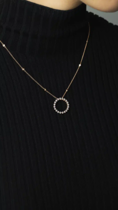  Crafted in 18ct yellow gold, this elegant circular pendant showcases 20 round brilliant-cut diamonds totaling 0.78–0.80ctw. Measuring 18.7mm across, it hangs from a 45cm trace chain. With its radiant sparkle and refined design, it's a timeless gift—perfect for marking a special moment or elevating everyday style with a touch of sophistication. 