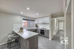  9 Basalt Dr Clyde North VIC 3978 $745,000 - $819,500 Stylish Family Living with Comfort & Convenience Offering the perfect blend of style, functionality, and low-maintenance living, this beautifully presented four-bedroom home is ideal for families, or savvy investors. At the heart of the home is a modern kitchen featuring sleek stone benchtops, stainless steel appliances, and generous storage perfectly positioned to overlook the light-filled open-plan living and meals area. Sliding doors extend the living space to a private patio, ideal for entertaining or relaxing, year-round. A separate cozy lounge provides the perfect retreat or additional space for growing families. The master bedroom boasts a private ensuite, while the remaining bedrooms are serviced by a well-appointed family bathroom. Set on a low-maintenance allotment with a vibrant, colourful garden, this home also features a double car garage with rear access, ideal for trailer storage. Perfectly positioned close to local schools, parkland, and shopping facilities, this is an exceptional opportunity to secure a quality home in a highly private enclave. 