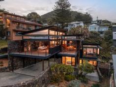  6 Kallaroo Avenue Stanwell Park NSW 2508 One of the most highly coveted properties in the Northern Illawarra is officially on the market. Designed by multi-award winning architecture firm, Casey Brown Architecture, this stunning residence is sure to impress even the most discerning of prospective purchasers. It takes a special location to do justice for such a special home, and the end of a quiet cul-de-sac, only steps from Stanwell Park Beach, with views extending over the beach and along the entire coastline, is just such a location. If you've always desired a lifestyle beyond the ordinary, look no further than 'Stanwell Park House'. YOUR HOME • Imagine waking up to breathtaking views of the sun rising over the horizon, before taking several steps from your front door and diving into the sparkling Pacific Ocean, then returning home to enjoy a hot shower and your morning coffee, while watching the waves rolling in. There is no better way to start your day. • This home utilises a blend of natural materials:- timber, stone and copper to create an environment that blends into the landscape while also offering a level of style and quality, rarely seen on this coastline. These materials were carefully selected to withstand the rigours of beachfront living, ensuring minimal maintenance is required throughout the life of the home. • Every aspect of the home has been carefully designed to consider the views, sunlight and topography of the land, while the layout is very functional as either a holiday beach house or full time residence. Minor changes in the levels of the home give each room a sense of purpose and privatisation while also offering that open, social aspect. As you walk through the home, it is easy to see the thought and consideration that have gone into this unique design. • A sundrenched entertaining deck is the perfect place to enjoy a BBQ with friends or alfresco meals with the family, while appreciating the beach vistas and ambient ocean sounds. • Life is too short to compromise on your dreams. This property offers you the lifestyle that you've always wanted, with its rare combination of style, quality and location. LOCATION • Perfectly positioned at the end of a quiet cul-de-sec street only a literal stones throw from the beach, with fantastic local cafes, school and public transport also only minutes walk. Embrace that relaxed coastal lifestyle with swimming, surfing, fishing, bushwalking and picnics in popular parklands all available only moments from your doorstep. • With the beach so close, you will undoubtedly spend many summer days enjoying the renowned surf breaks, natural lagoons and fully patrolled swimming. The beach is also dog friendly so even your four legged family members can enjoy it with you. • Stanwell Park is one of the most desirable suburbs on this pristine coastline. It is the perfect coastal retreat approximately 1 hour South of Sydney CBD and approximately 30 minutes North of Wollongong CBD. • The popular walking track, only 1 minute from your home, takes you along the coastline and across the iconic Seacliff Bridge, providing a beautiful setting for your morning walks. At the end of which is the Imperial Hotel offering meals, coffee or cocktails. • Stanwell Park offers a community-based village lifestyle by the sea with easy access to Sydney and Wollongong and all that the Northern Illawarra has to offer. 