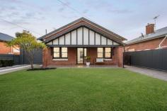  3 Stanton St Edwardstown SA 5039 Classic Character meets Contemporary Entertainer Timeless character combining with a stunning rear extension, an enviable location in a peaceful Edwardstown pocket is the icing on the cake of this gorgeous 1926-built Bungalow home. An immaculate red brick façade sits behind a generous front lawn area, contemporary blade fencing making it a secure space for little ones and four-legged friends. Lined with pine timber floors and high ceilings, a central entry hall offers easy access to two front bedrooms - either of which could stake claim as the master - both enjoying lovely street outlooks and ceiling fans, one with ornamental open fireplace and the other with large mirrored built-in robes. Doors on either side allow for a comfortable lounge room with combustion heater to be made extra cosy during the cooler months, with access to the extension as well as a third bedroom with built-in robes. A raked ceiling and feature brick wall beautifully blend old to new in the expansive rear addition housing an open plan kitchen, living and dining space with uninterrupted views of the backyard. A convenient combustion-look gas heater, ceiling fans and a split system will keep the temperature perfect here, while the main bathroom has been stylishly renovated with floor-to-ceiling tiles, floating vanity, skylight, full-size bath and frameless shower. Home cooks will delight in their white galley-style kitchen with gas cooktop, glass splashback, dishwasher, endless bench and storage space and breakfast bar, while bifold doors opening onto a huge rear deck are what entertainer's dreams are made of. Under the protection of a large pergola with café blinds and ceiling fan, the deck with built-in BBQ area with fridge and storage will make outdoor entertaining readily available all year round, while an inground pool and lawn area will provide plenty of their own entertainment during warmer weather. An added highlight is the sizeable attic with plenty of capacity to utilise as a home office, if not invaluable extra storage space. So much more you'll adore: - Electric gated access to double-length carport + extra driveway parking - Alarm system - Separate laundry with access to second toilet + linen storage - Rear Extension capturing some of the Northern winter sun - Evaporative cooling to front half of the home - Wood + tool sheds With easy access to the bus and train, Castle Plaza Shopping Centre, Edwardstown Oval, local hotels and reserves, there's lots you'll love about the location, just 8kms from the heart of the CBD and even less to some of our most beautiful beaches. 