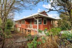  39 Hat Hill Road Blackheath NSW 2785 $865,000 - $895,000 Offering many of the hallmarks of an endearing mountain home, this warm and welcoming cottage has been sympathetically refreshed from top to toe. With fresh paint and brand new carpets throughout, updated bathrooms and a brand new ducted gas heater furnace, this is a home where you can walk straight in and feel immediately at home. Bathed in natural light, the home enjoys privacy to the fore and rear. Entering into the open plan living, dining and kitchen area, there are windows on all sides and a cosy slow combustion fire makes this a very comfortable setting. A sun dappled verandah faces north and is the perfect place to sit and enjoy relaxed downtime. Both bedrooms have their own bathrooms and an oversized laundry gives external access down to the under house area. A single garage, a third WC and an expansive creative space with full garden views and its very own slow combustion fire make this a very attractive addition. Those with a keen interest should add Gang Gang Cottage to the priority viewing list without delay. Breakdown of Features: Within a 900m stroll from village cafes, shops and amenities Freshly schemed throughout with neutral tones and new carpets Two queen bedrooms each with their own bathroom Ducted gas heating; s/c wood fire in open plan living area Covered north facing entertaining verandah with access from hallway and main bedroom Light-filled upgraded original kitchen with ample storage cabinets Spacious laundry with external access down to under house area Single garage with access to 3rd WC and expansive creative space Creative space with s/c fire and surrounding windows offering garden views Well established gardens with fruiting orchard 