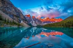 Witness the breathtaking beauty of Alberta’s iconic Moraine Lake at sunrise with this fine art print by Andy Denton. Capturing golden light over turquoise waters and towering peaks, this peaceful landscape scene brings natural elegance to any room. Available in custom sizes and finishes.