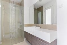  4/1311 Toorak Road Camberwell VIC 3124 $868,000 Nestled at the rear of a striking architectural development, this thoughtfully designed, low-maintenance three-bedroom town residence is bathed in natural light. Enhanced by double glazing for a 6-star energy rating and a peaceful ambiance, it offers a picturesque garden view with seamless access to an inviting outdoor courtyard through sliding patio doors. The open-plan living area features a designer kitchen with stone benchtops and premium Miele appliances, complemented by a convenient downstairs powder room. Upstairs, the generously sized bedrooms, including a master with ensuite, are fitted with built-in robes and are serviced by a stylish central bathroom. Additional highlights include video intercom, secure entry, polished timber floors, ducted heating and cooling, and a spacious double garage with remote control access. Located for ultimate convenience, this property is surrounded by transport options, shops, restaurants, a supermarket, and a medical center, all within walking distance. It is also close to parks, public and private schools, including Hartwell Primary, Wattle Park Primary, Deakin University, and Presbyterian Ladies College, just a short tram ride away. This exceptional residence is perfect for professional couples, investors, and downsizers seeking a low-maintenance lifestyle with access to premium amenities. 