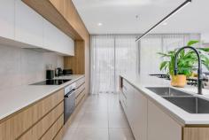  1 / 37 Twenty Seventh Avenue Palm Beach QLD 4221 $2,195,000 Set within a short stroll of popular beaches and the calm waters of Tallebudgera Creek, this architect-designed villa is one of four within boutique development 'The Palms'. Offering a laid-back, coastal lifestyle in the tightly-held northern part of Palm Beach, this tri-level home completed in 2021 is a flawless example of contemporary coastal design. Stone, VJ panels and earthy timber tones, elevate the fresh, breezy interior. Each floor hosts one of three bedrooms and bathrooms, with the master suite located on the top floor having an additional study or parents retreat. Natural light bathes the refined design, most notably through an elevated void to the open living, dining and kitchen area. filtering in through elegant glazed archways. Sliding doors open to a covered balcony, encouraging effortless indoor-outdoor entertaining and cross flow coastal breezes. Tucked away in a peaceful pocket of vibrant North Palm Beach, this viaal promises front-row access to a relaxed way of life centred around sun, sand and surf. The Highlights: - Architect-designed tri-level villa in Palm Beach - One of four residences making up boutique 'The Palms' development - Flawlessly completed by Alroe Constructions in 2021 - Contemporary coastal design with laminate timber, stone, arched glazing and VJ panelling - Open living, dining and kitchen area with balcony access - Living has 5.3m void; dining has arched glazing for natural light - Gourmet kitchen has stone island benchtop with breakfast bar, Bosch oven, integrated dishwasher and induction cooktop - One bedroom and bathroom on each level - Entire top-level master suite has walk-in robe, ensuite with his and her vanity, and private study or sitting area - Two additional bedrooms with built-in robes - All bathrooms have floor-to-ceiling tiles - Laundry has access to external drying court - Heated pool - Fully fenced, private yard - Ducted air conditioning throughout - Double garage Enjoy an amazing mix of lifestyle and location boasting a superb gourmet cafe precinct, hipster stores, restaurants and bars including Custard Canteen and Bantr. In PBC catchment and within close proximity are the Mallawa Sports Fields, revered local schools and 10 minutes Gold Coast International Airport. 