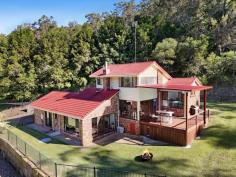  18 Tuesday Drive Tallebudgera Valley QLD 4228 Set on almost 3 acres of private bushland this secluded property offers an exceptional lifestyle for families seeking space and serenity without compromising on convenience. Designed to embrace the natural slope of the land, the home unfolds across a series of levels where thoughtful modern upgrades enhance internal structural features of raked ceilings and internal exposed brick. An inviting saltwater pool, huge timber deck and large multipurpose studio combine for the perfect venue for large scale celebration and adds a layer of versatility to this property. All of this situated within an idyllic hinterland setting just minutes from schools, shops and Burleigh's vibrant coastal lifestyle. A sophisticated kitchen with gas cooking and double ovens is set to impress and the central island with breakfast bar will invite company and conversation for the chef. Join the family in the adjacent dining area, move to the deck for alfresco meals with friends or gather in the sunlit living room where a fireplace promises a cosy ambience on those cooler nights. Three bedrooms feature on the floorplan across the upper levels. Two bedrooms, each with ceiling fans and built-in robes share the main bathroom with double basin vanity and dual head shower over bath. The top level of the home is given over to the master suite, a welcome sanctuary with both walk-in robe and ensuite. Outdoors you'll discover the poolside entertainment zone that will be the envy of your friends - a fabulous hub to relax and recharge or host memorable special occasions. The studio with kitchenette and powder room also offers further flexibility – ideal for a home office or private guest retreat. Additionally, a third full bathroom and built-in storage can be found in the double garage while a large shed with adjoining carport/woodshed provides further practical infrastructure. This location promises a tranquil valley feel without sacrificing access to essential amenities. Tallebudgera State School, St. Andrews Lutheran College and local shopping are all reached within a 7 minute drive and only 10 minutes away is Burleigh Heads with renowned beaches and a vast array of dining options. Currumbin Beach, Kingscliff and Surfers Paradise are also easily accessible within a half hour drive. House Features • Modern kitchen custom cabinetry with 5-burner gas cooktop, double oven & island bench • Lounge room with fireplace and raked ceiling • Dining area with air-conditioning and built-in cabinetry • Expansive poolside studio/multipurpose room with kitchenette and powder room • Top floor master suite with walk-in robe, ensuite and air-conditioning • Two additional bedrooms with built-ins and ceiling fans • Family bathroom with double vanity and dual shower heads • Laundry with linen cupboard and external access • Double garage with internal access, built-in storage and bathroom • Multiple outdoor living and entertaining zones • Saltwater pool with surrounding timber deck and outdoor shower • Secluded property on 11615m2 in private Tallebudgera Valley setting • Double bay shed with adjoining carport/woodshed • Shade sail parking Location • 7 mins approx. to Tallebudgera State School, St. Andrews Lutheran College • 7 mins approx. to local shopping • 10 mins approx. to Burleigh Heads • 16 mins approx. to Currumbin Beach • 19 mins approx. Gold Coast Airport • 24 mins approx. to Kingscliff Beach • 30 mins approx. to Surfers Paradise 